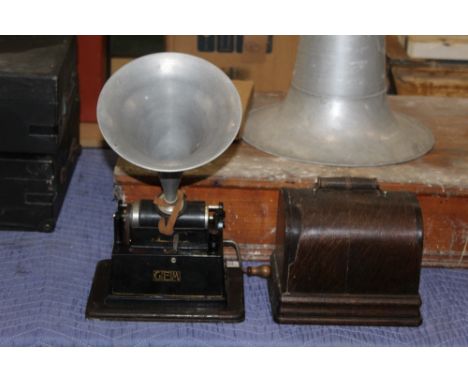 An Edison Gem phonograph in oak case, 25 cm wide, with winding handle and sold with an aluminium horn and a cylinder (some ol