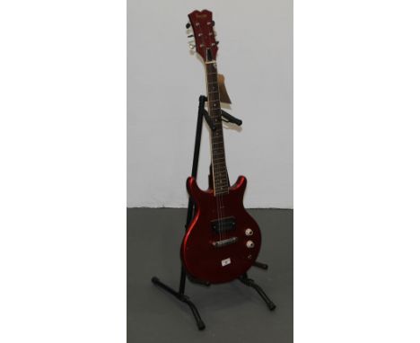 A 1980's Vulcan 6 string electric guitar with metallic red lacquered body, 97 cm long (with paint chipping) and with a guitar