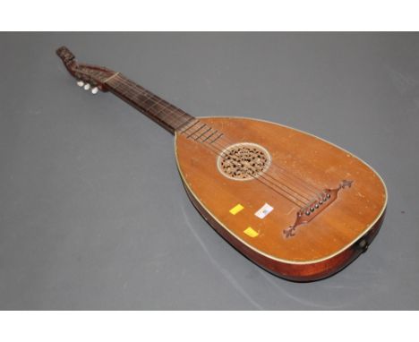 A mid 19th century German Lute guitar by Rosetti, with leaf carved scroll and fretwork to centre of body, 95 cm long. CONDITI