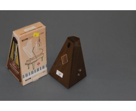 A Wittner metronome, in mahogany finish case, as new.  Height 22 cm, boxed. 