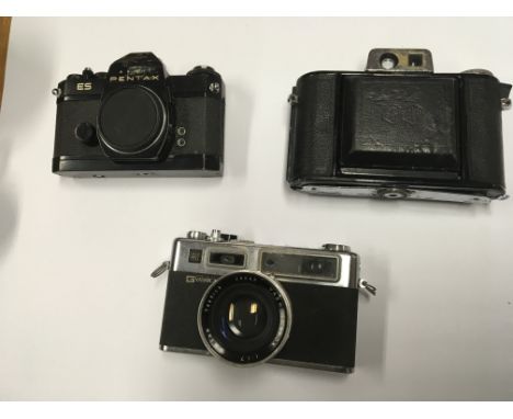 A group of three cameras to include a Pentax ES, Agricola camera and a Yashica Electro 35G camera with lens