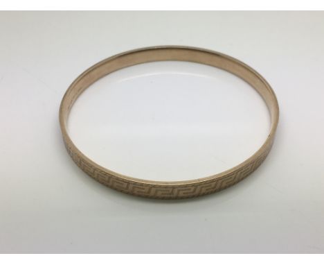 An 18ct gold plated bangle, approx 32.4g.