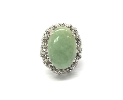 An 18ct white gold ring set with a large central jade stone. Total weight approx 13.3 grams, ring size R/S.