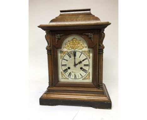 A German walnut mantel clock with a silvered dial and gilt mounts maker HAC 14 day striking with applied label.