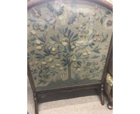 A walnut fire screen with needle work tapestry inset