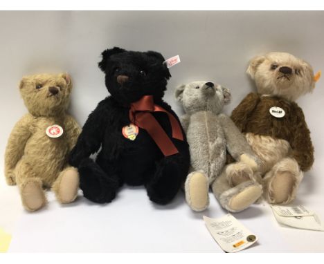 Four Steiff  teddy bears three with original hanging tags with attached Steiff booklets.