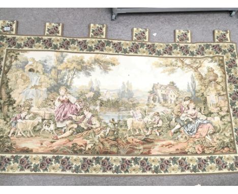 A Flemish tapestry depicting figures at leisure with buildings beyond with applied hanging loops. 182x105cm.