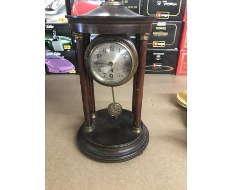A mahogany four pillar clock the circular dial with Arabic numerals