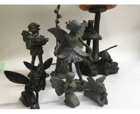 A side lamp in the form of a fairy sitting on a toad stool and a collection of other fairy's