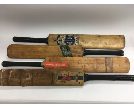 Four vintage cricket bats.