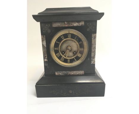 A Victorian black slate and marble mantle clock fitted with a French movement on a gong. With pendulum and key.