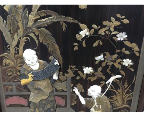 A fine quality Japanese lacquer and ivory Shibiyama firescreen depicting figures in a garden setting, approx 93cm x 105cm.