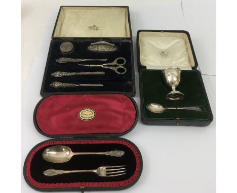 Three cased silver items comprising a Mappin and Webb eggcup and spoon, manicure set, incomplete, and a fork and spoon