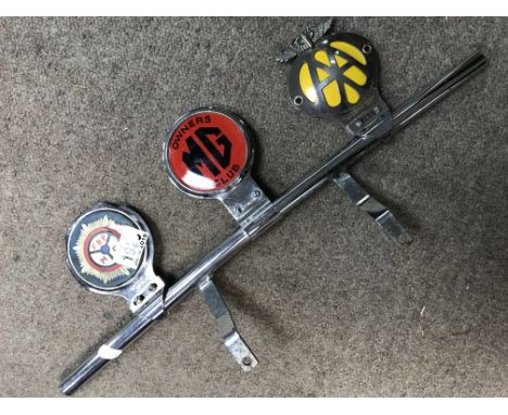 A vintage chrome badge bar with three badges including. ZM G owners club
