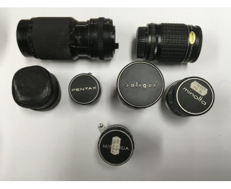 A group of camera lenses to include Minolta, Pentax, Takumar and others