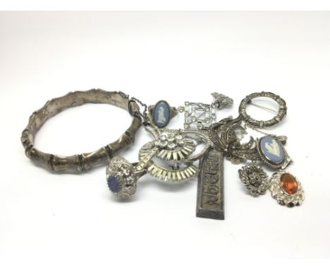 A collection of silver and white metal jewellery oddments to include rings, a bangle, necklaces etc.
