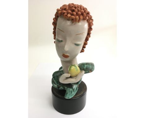 An Art Deco,  Goldscheider pottery bust of a girl holding an apple.Nameplate to base, approx 26cm , some damage.