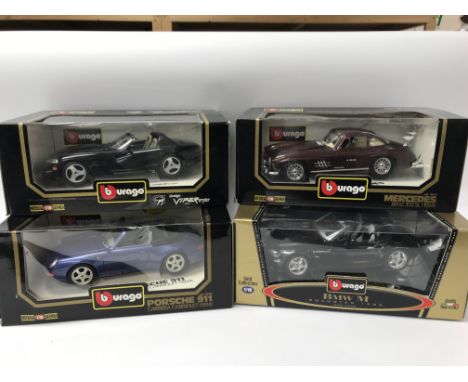 A collection of boxed 1:18 scale diecast vehicles including Burago, Dodge Viper, Mercedes Benz 300SL, Porsche 911 Carrera cab