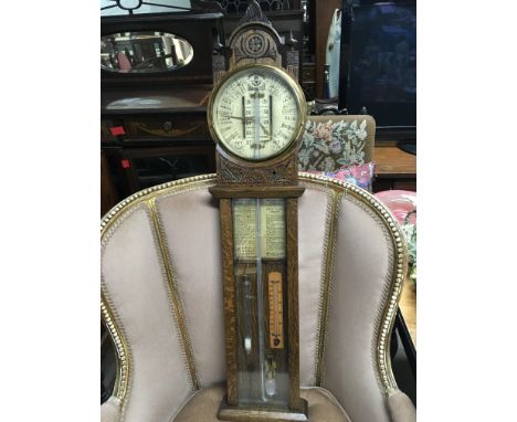 A Victorian oak Admiral Fitzroy Barometer with mercury tube weather chart.