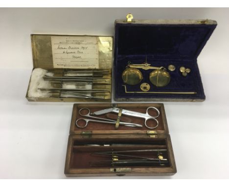 Two sets of surgeon's scalpels and a cased set of brass scales (3).