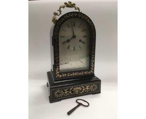 A French inlaid arch top 8 day mantle clock with day/date apertures and striking on a bell, approx 29cm. Comes supplied with 