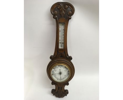 A carved oak barometer