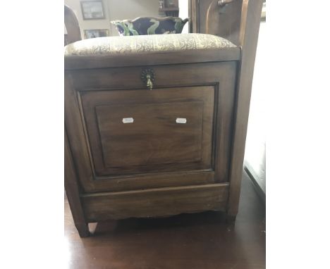 A Edwardian mahogany piano stool with upholstered seat and fall front