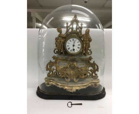 A figural clock under a glass dome, the white enamel dial having a finely dressed lady and a gentleman to either side, approx