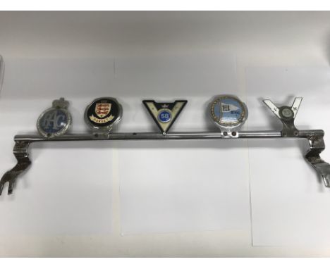 A large vintage chrome badge bar with five badges, including Dorset, RAC, GEM, B.Y.C Yacht Club and the V 23 M. Length approx