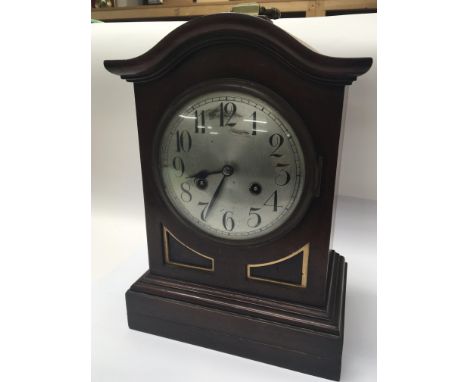 An Edwardian Mahogany mantle clock with a silvered dial.