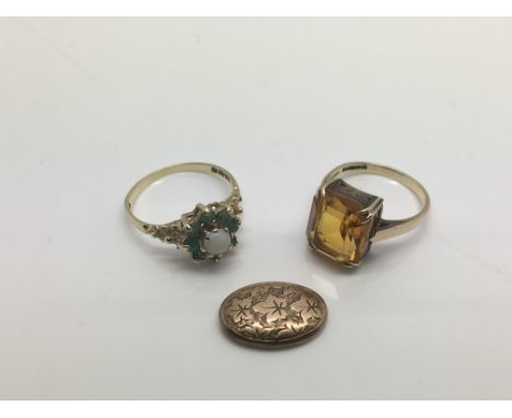 Two gold rings, one set with a central opal, the other set with citrine, together with a gold cufflink (3), approx 5.9g.