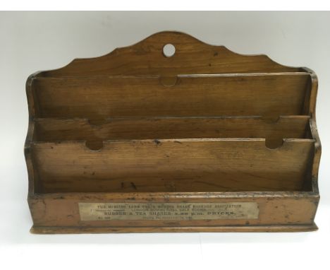 An Edwardian letter rack with an applied label from the Mincing Lane tea and rubber share broker's association dated 1911.