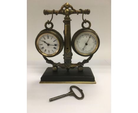A brass cased clock and barometer set within an anchor, approx 20cm in height.