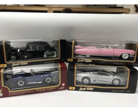 A collection of boxed 1:18 scale diecast vehicles including, Maisto special editions, Citroen 15CV, Cadillac Eldorado Biarrit