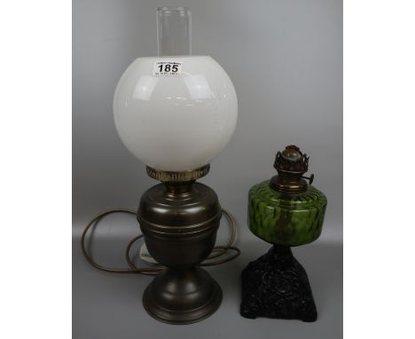 Oil lamp with green glass reservoir and a converted oil lamp 