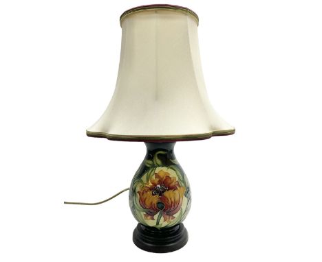 Moorcroft table lamp of baluster form, decorated in Fire Flower pattern, with Moorcroft cream fabric shade with gold, green a