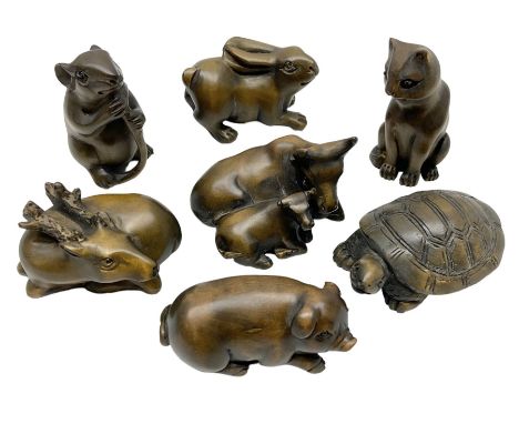 Seven netsuke, modelled as a cat, rat, pig, deer, cow and calf, turtle and rabbit
