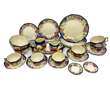 Early 20th century Art Deco Royal Doulton Pansies pattern octagonal teawares, comprising three larger teacups and saucers, th