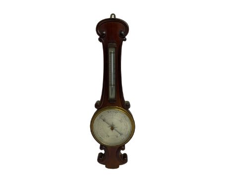 Early 20th century aneroid barometer c1910 in a scroll carved mahogany case with a silvered dial, brass bezel and flat glass,