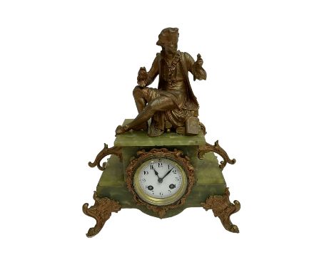 An early 20th century French striking mantle clock c1910, in a green variegated onyx case on cast metal rococo feet and surmo