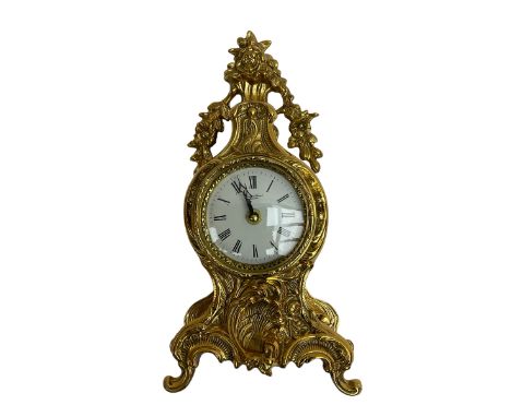 20th century gilt metal timepiece mantle clock with a Quartz movement,case in a decorative baroque style with a white enamel 
