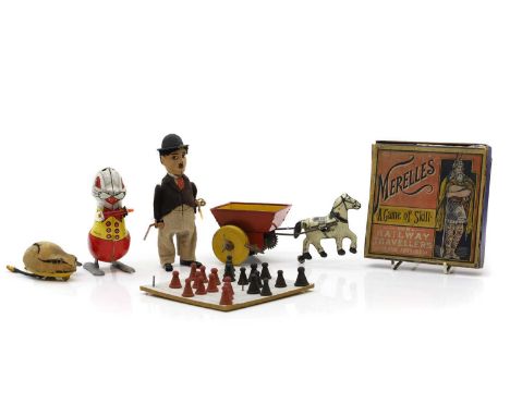 A collection of tin plate toys, 1930s, comprising a Schuco clockwork 'Charlie Chaplin' figure, with key, fabric-covered tinpl