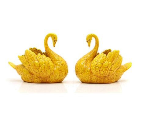 A pair of Burmantofts faience pottery vases 19th century, modelled as swans, in a yellow glaze, impressed marks,19cm wide17cm