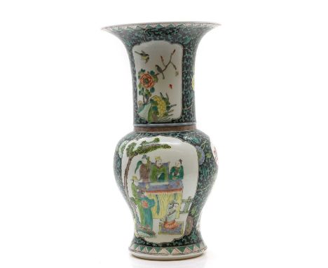 A Chinese famill noire vase, 20th century, of baluster form with a trumpet mouth, painted with figures, birds and flowers in 