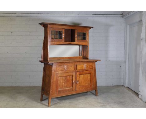 A Liberty Arts and Crafts oak sideboard, c.1900, the superstructure with two bar-glazed doors, each with a copper ring handle