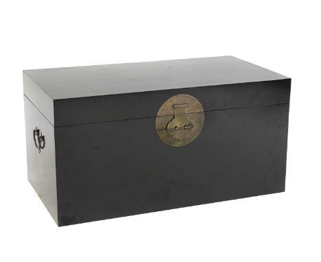 A Chinese black lacquer trunk, 20th century, of rectangular form with gilt metal escutcheon and carrying handles 95cm wide 52