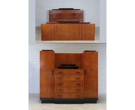 An Art Deco walnut and ebonised bedroom suite, c.1930, French, comprising:a breakfront wardrobe, the central chest of five dr