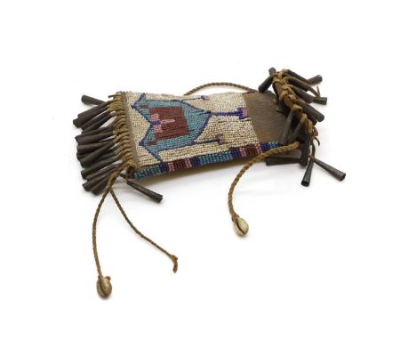 A North American Plains beaded strike-a-light bag, c.1900, the conical metal tassels, with two cowry shells, 13cm x 8cmCondit