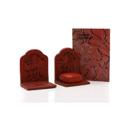 A pair of Chinese cinnabar lacquer book ends  late 19th to early 20th century, profusely carved with scenes of figures within