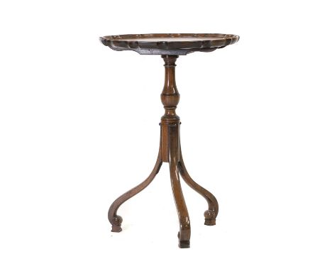A George II-style walnut tripod table, late 19th/ early 20th century, with a hinged piecrust top and a turned column, raised 